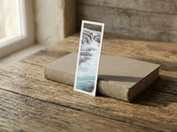 Turquoise Cascade fine art bookmark resting on a linen-bound book in soft window light