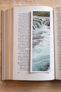 Turquoise Cascade fine art bookmark resting in an open book, close-up