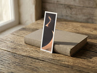 Yin Yang fine art bookmark resting on a linen-bound book in soft window light