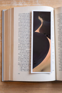 Yin Yang fine art bookmark resting in an open book, close-up